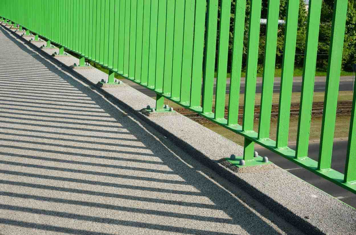 closeup base green barrier overpass bridge
